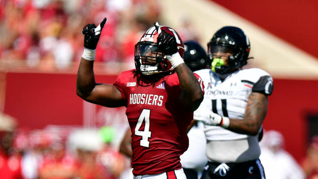 Cam Jones motions the number one after stopping a run during the first quarter against the Cincinnati Bearcats at Memorial Stadium.